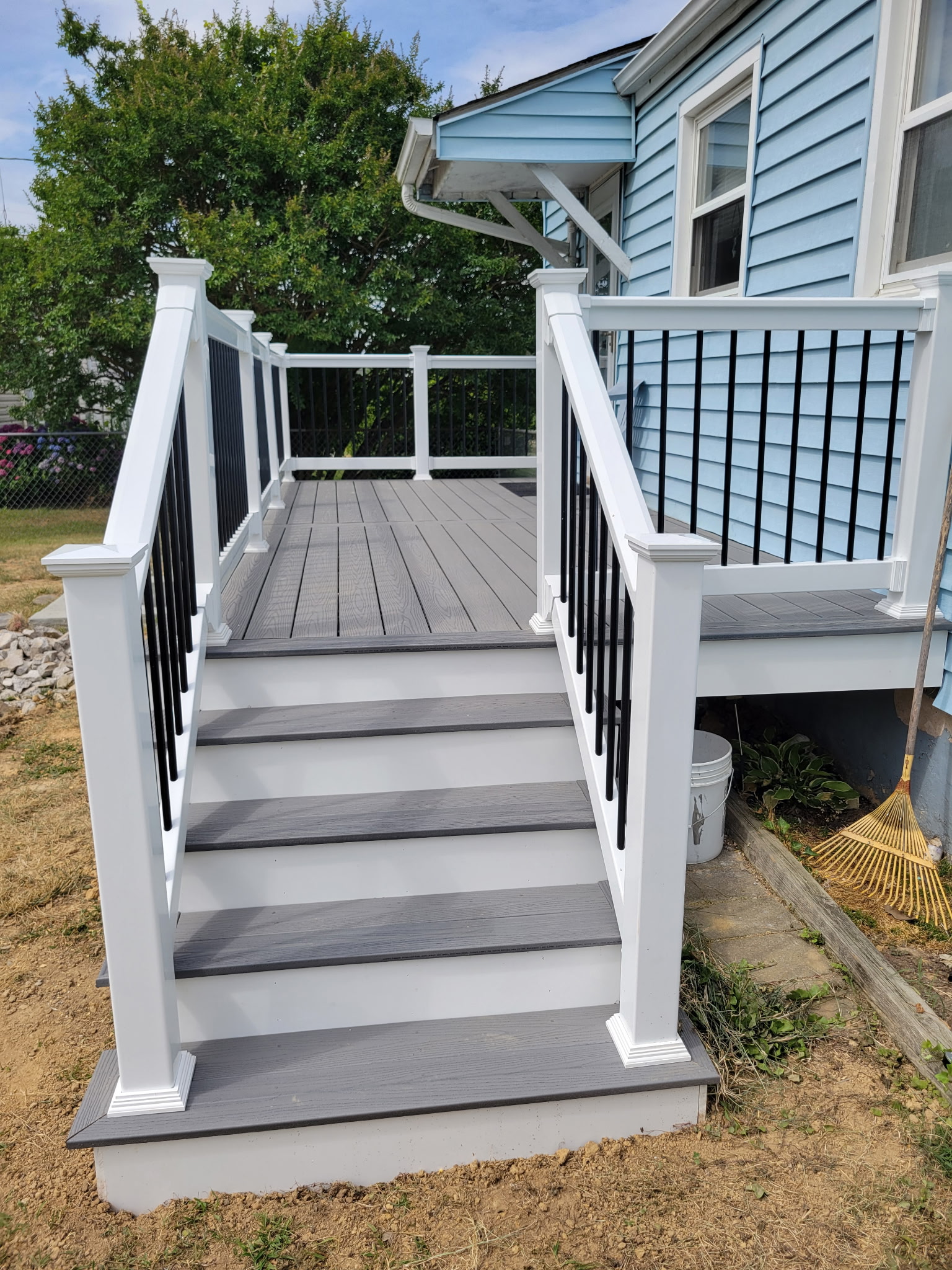 New gray composite deck with white railing and black balusters